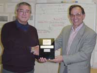 Dr Qun Son receives the KEDRI Efforts and Professionalism Award for the year 2004 and 2005 from Prof Nik Kasabov.